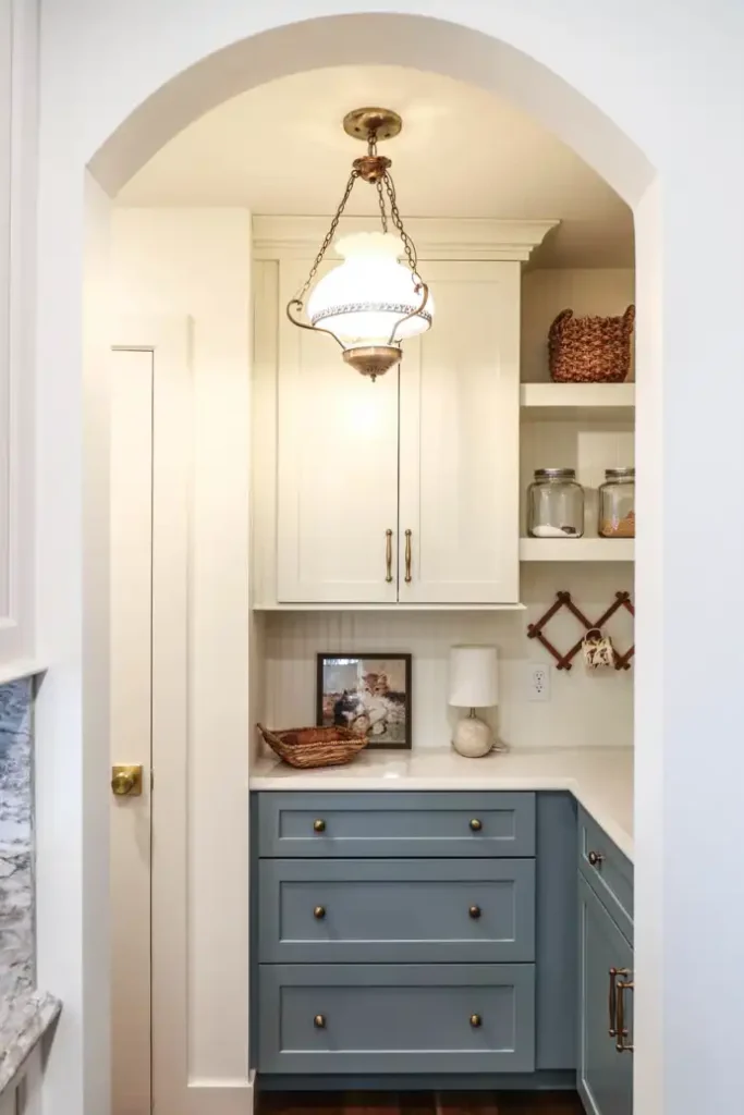 GRAVEL LANE DESIGN - Mixing Old & New: A Tour of This Charming Home Remodel - beautiful remodel of a kitchen with a small chandelier underneath an arched doorway