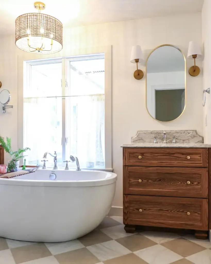 GRAVEL LANE DESIGN - Mixing Old & New: A Tour of This Charming Home Remodel - beautiful remodel of a bathroom with a small vanity and sink next to a domed tub