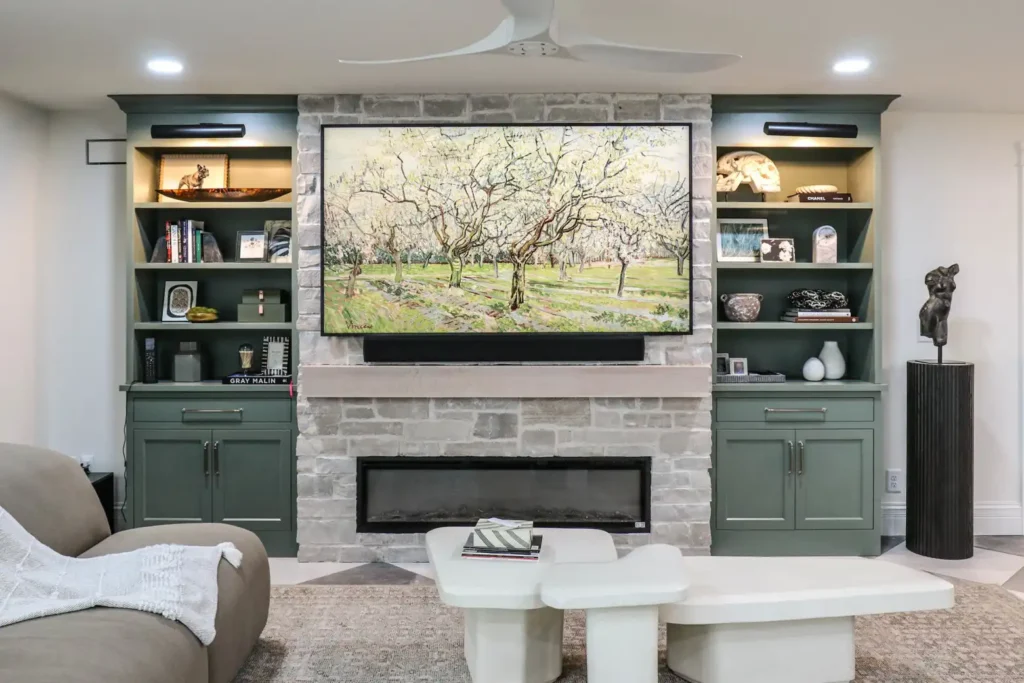 GRAVEL LANE DESIGN - Interior Design Principles and How to Apply Them to Your Home: a beautiful family room with a large TV encased with beautiful sage green bookcases